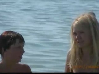 Adorable fresh faced teen plays at the beach nude